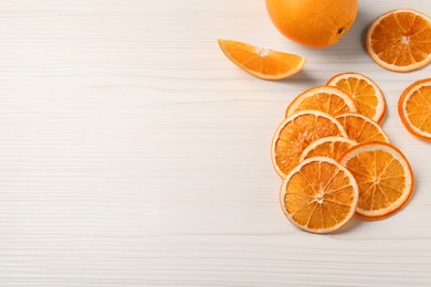Photo of Dry and fresh orange slices on white wooden table, flat lay. Space for text