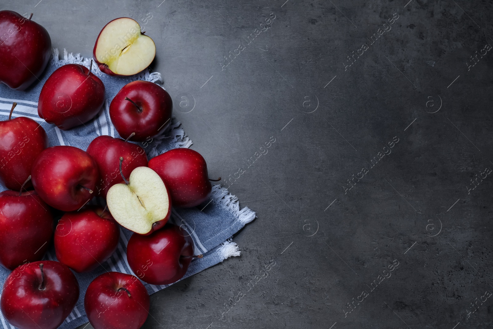 Photo of Fresh ripe red apples on grey table, flat lay. Space for text