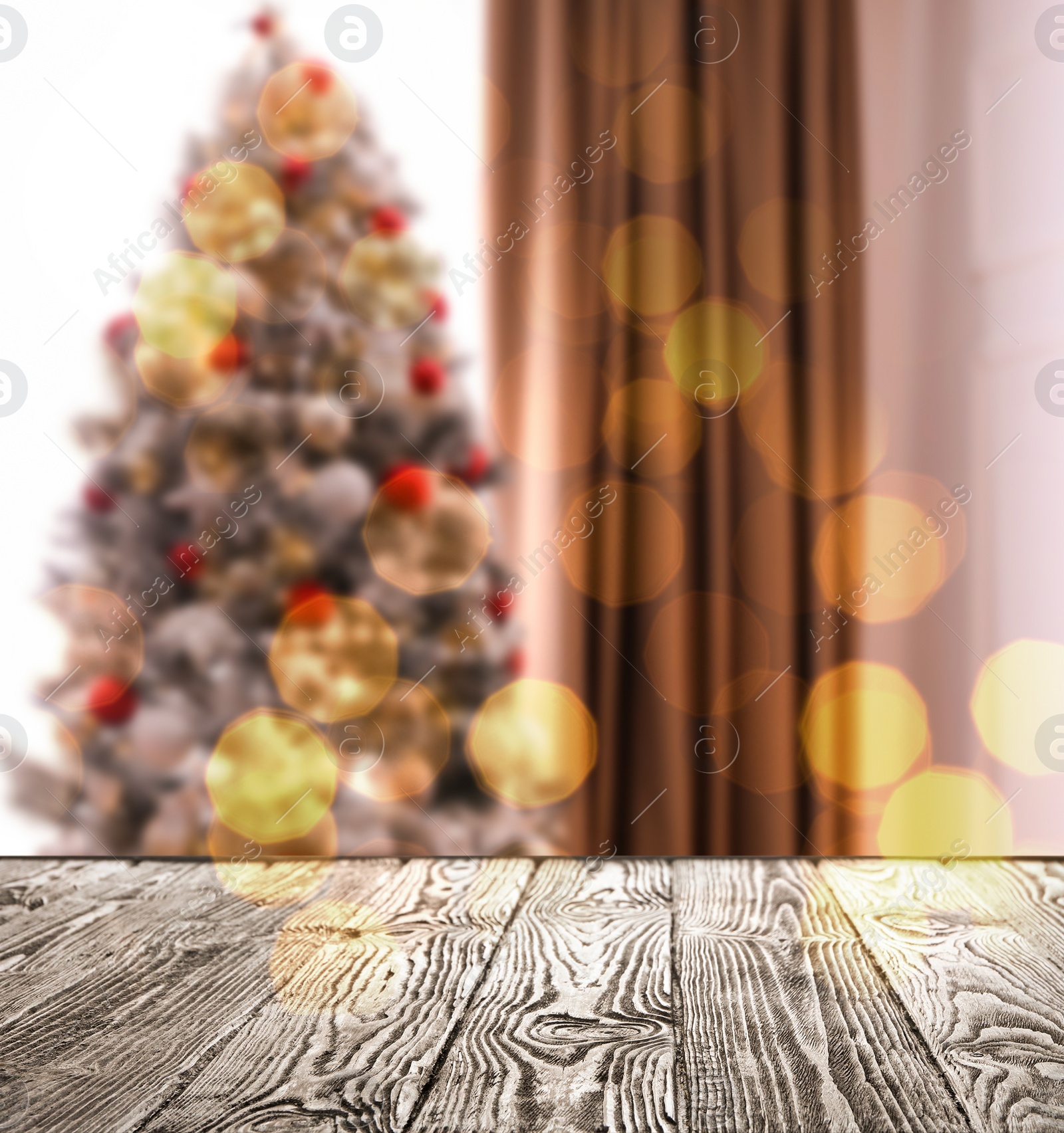 Image of Empty wooden surface and blurred view of Christmas tree in room, space for text. Interior design