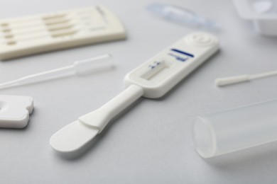 Photo of Disposable express test kits on light grey background, closeup