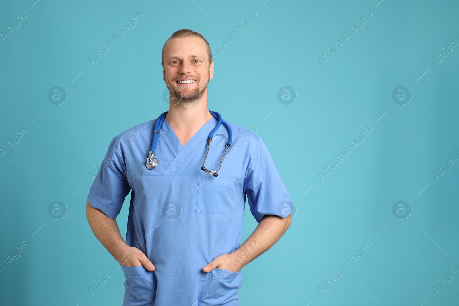 Photo of Portrait of medical assistant with stethoscope on color background. Space for text