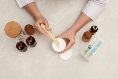 Photo of Dermatologist developing cosmetic product at light marble table, top view