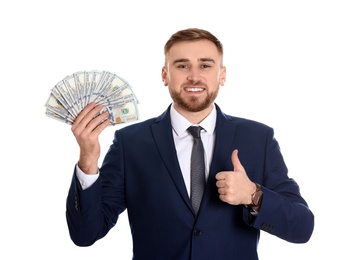 Portrait of young businessman holding money banknotes on white background