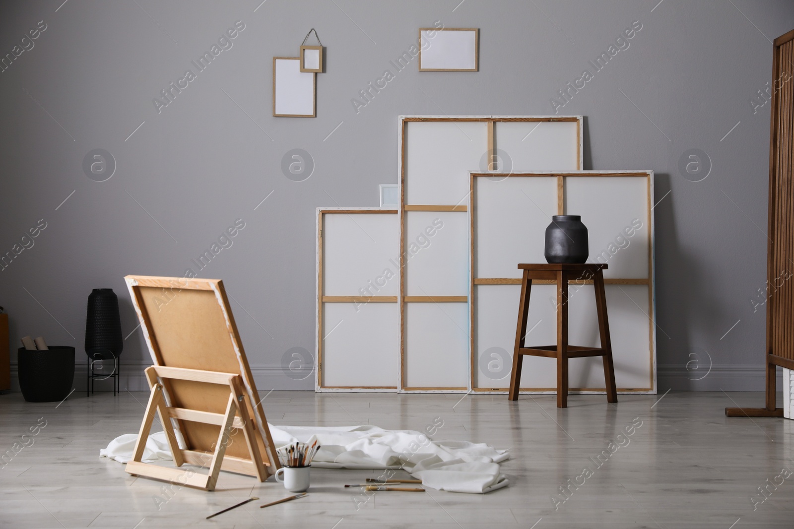 Photo of Stylish artist's studio interior with canvas and brushes