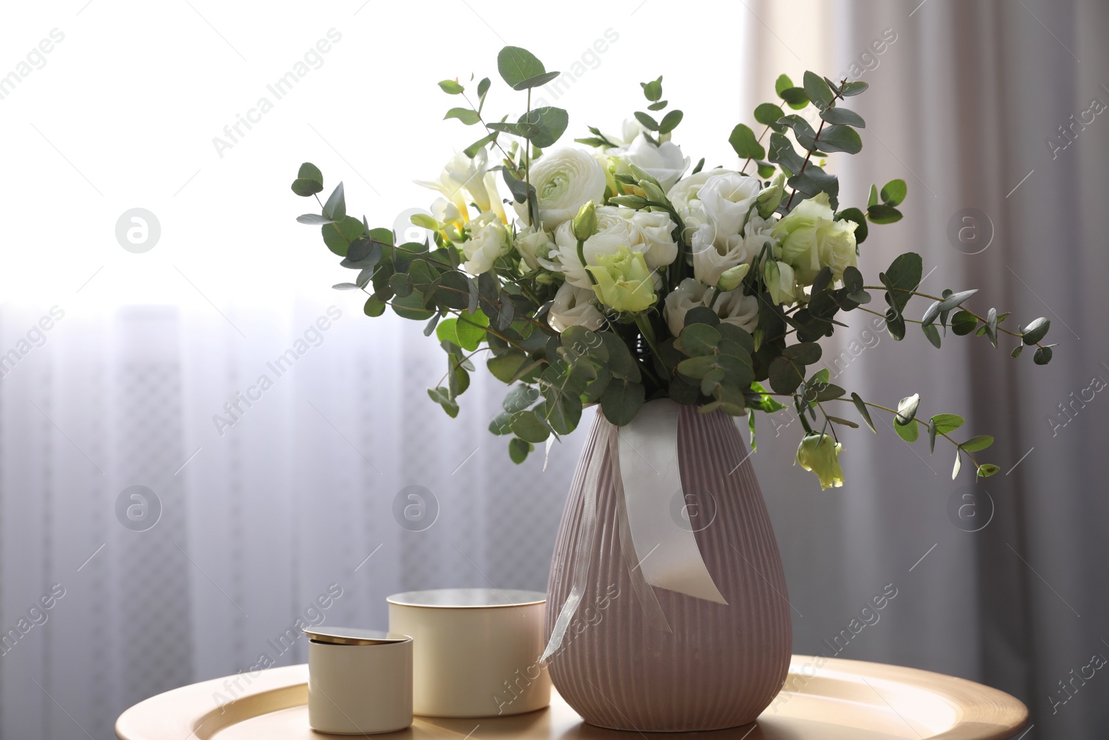 Photo of Beautiful bouquet of flowers on table in room. Stylish interior design