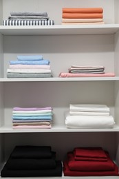 Bed linens and pillows on shelves in shop