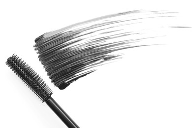 Photo of Smear of mascara and applicator isolated on white, top view