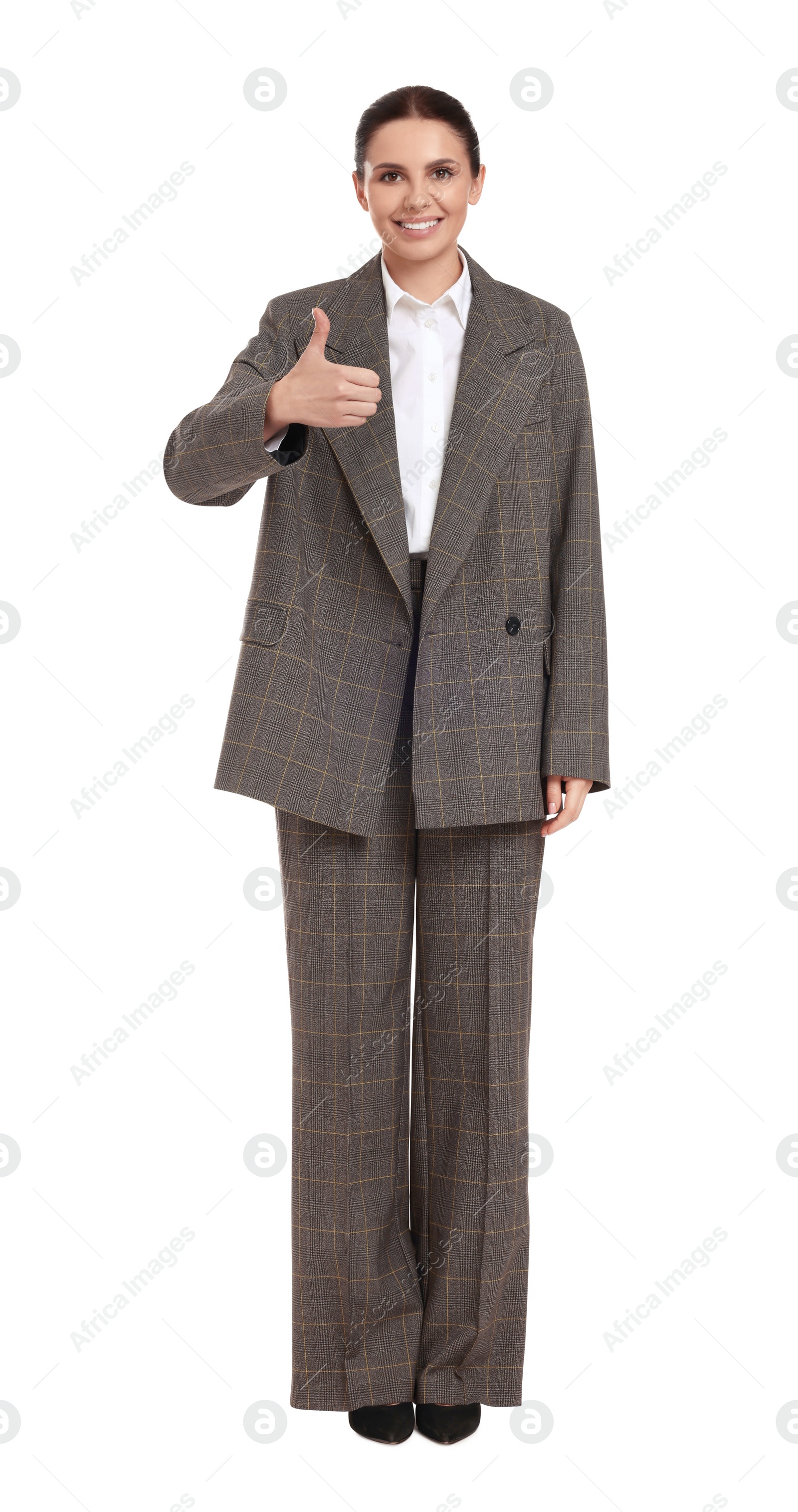 Photo of Beautiful businesswoman in suit showing thumbs up on white background