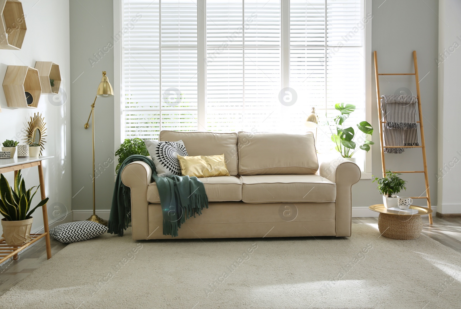Photo of Stylish beige sofa in modern living room interior