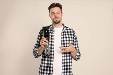 Man holding sous vide cooker on beige background