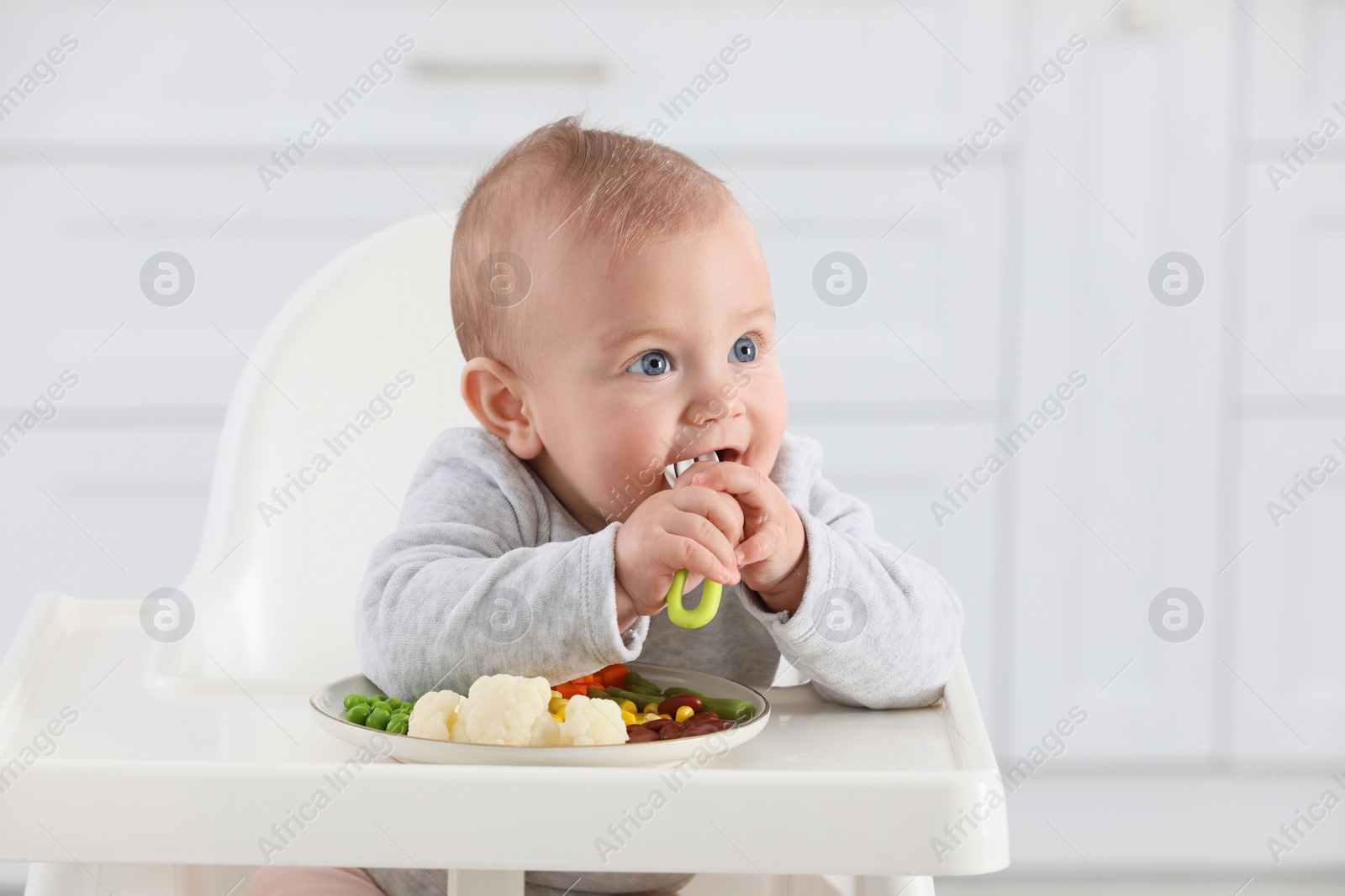 Photo of Cute little baby eating healthy food at home