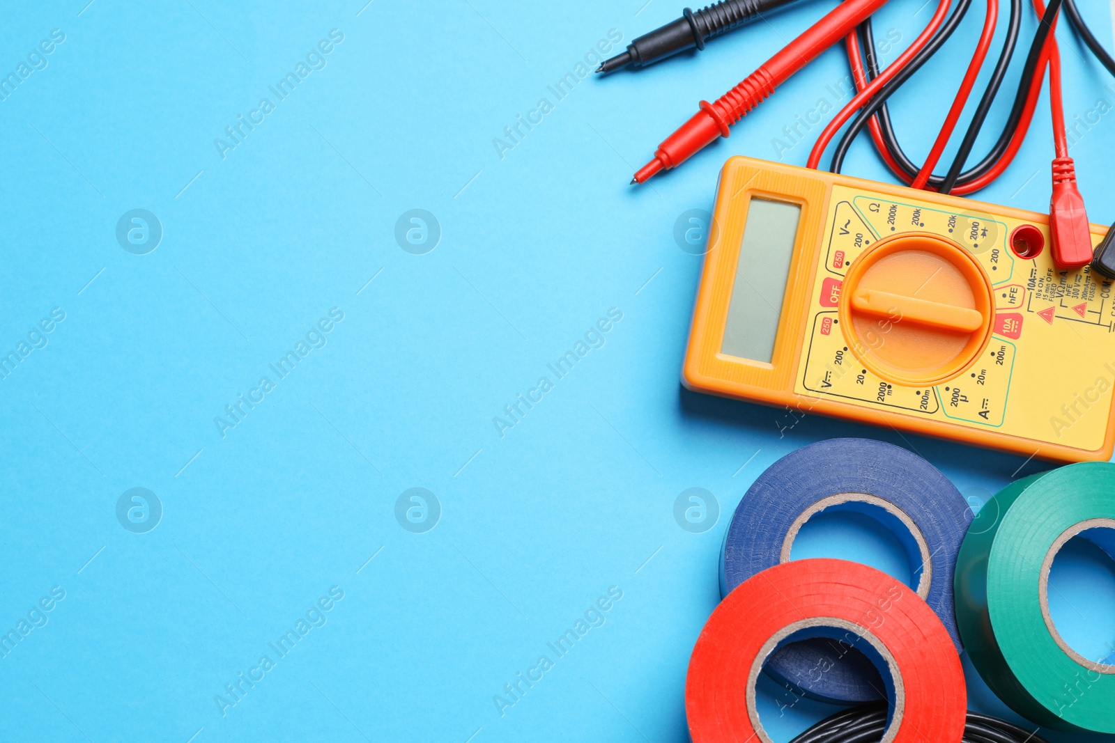 Photo of Flat lay composition with electrician's accessories on light blue background, space for text