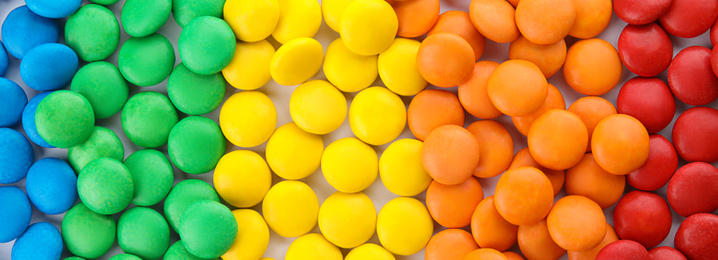 Image of Many colorful candies as background, top view. Banner design 