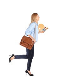 Photo of Businesswoman with painting materials and briefcase running on white background. Combining life and work