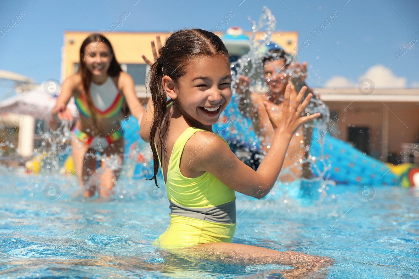 Photo of Happy family having fun at water park. Summer vacation