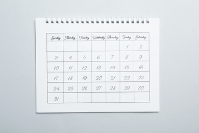 Paper calendar on light grey background, top view