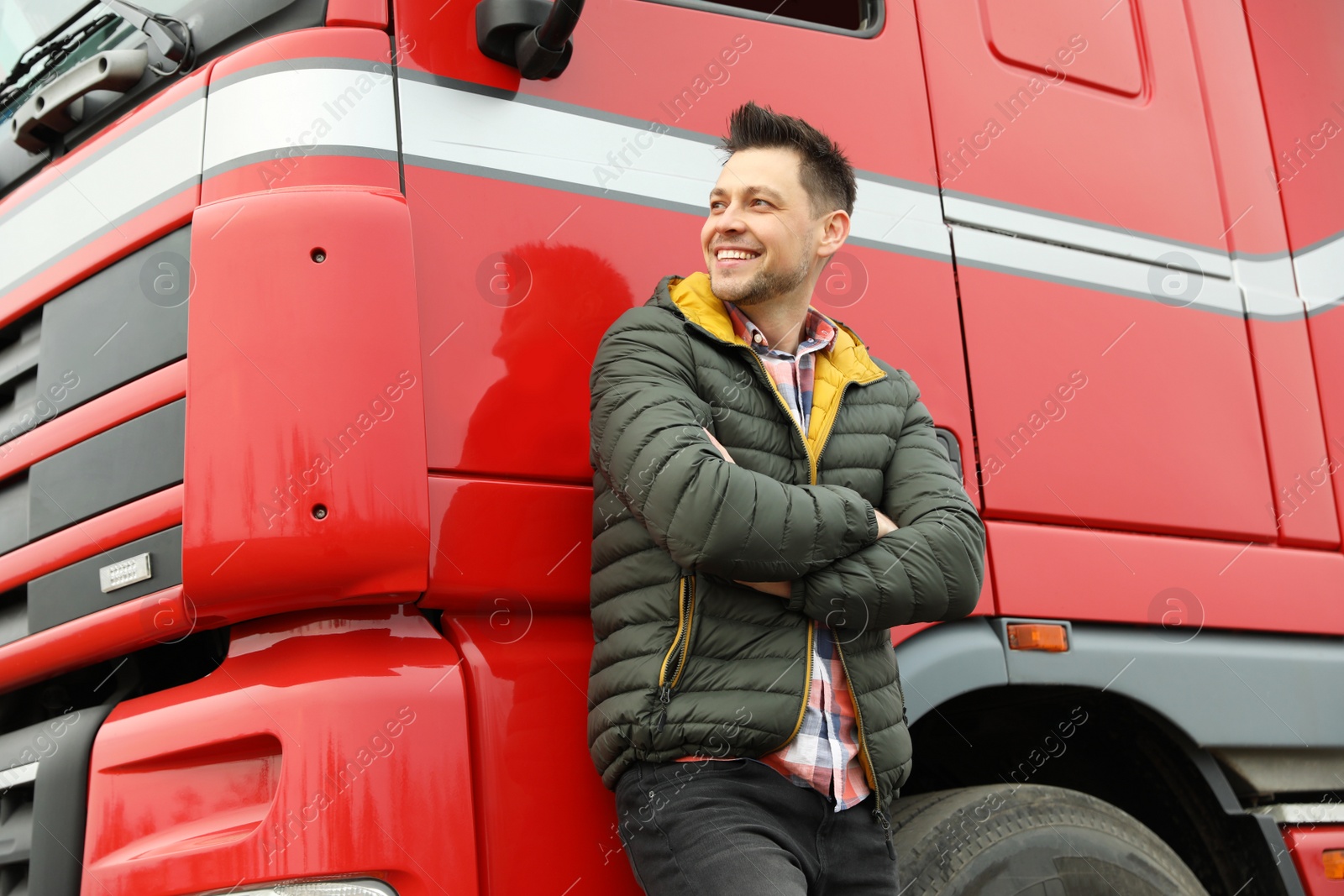 Photo of Portrait of happy driver at modern truck outdoors