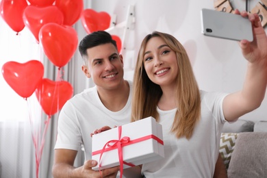 Lovely couple taking selfie at home. Valentine's day celebration