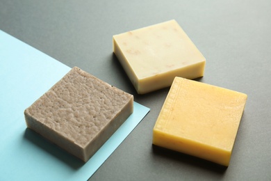 Hand made soap bars on color background