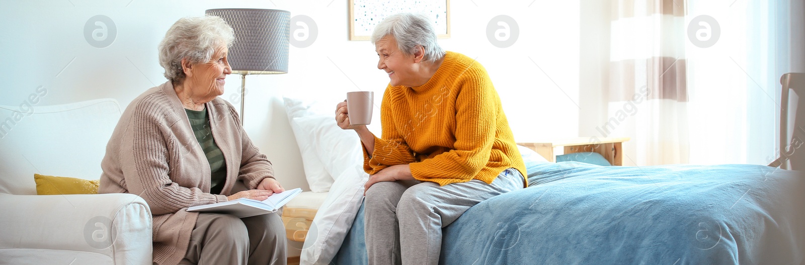 Image of Elderly women spending time together in bedroom, banner design. Senior people care