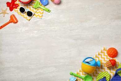 Photo of Flat lay composition with beach toys on light background. Space for text