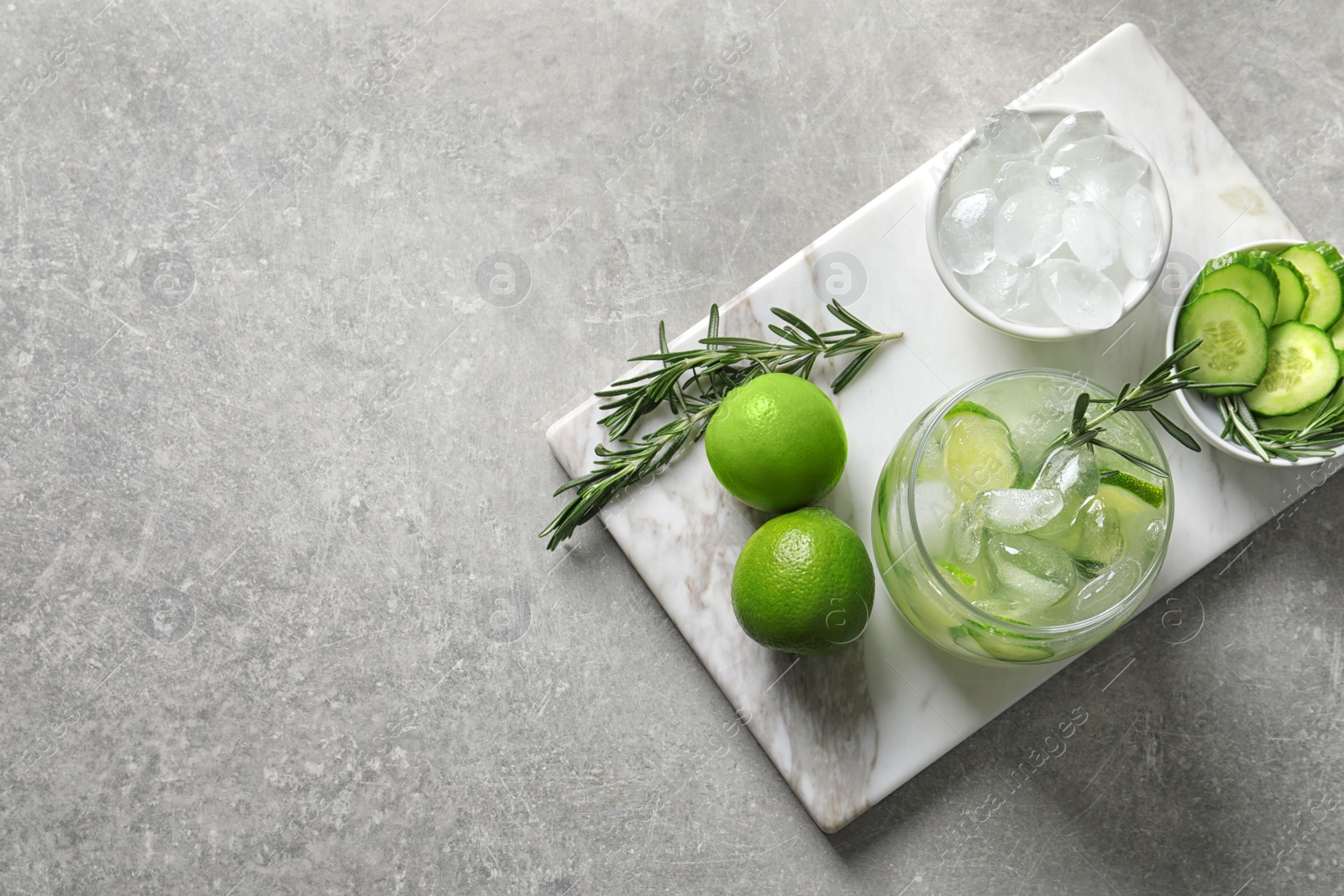 Photo of Jar with fresh lemonade and ingredients on table