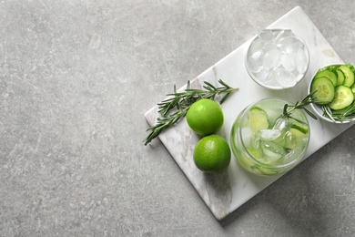 Jar with fresh lemonade and ingredients on table