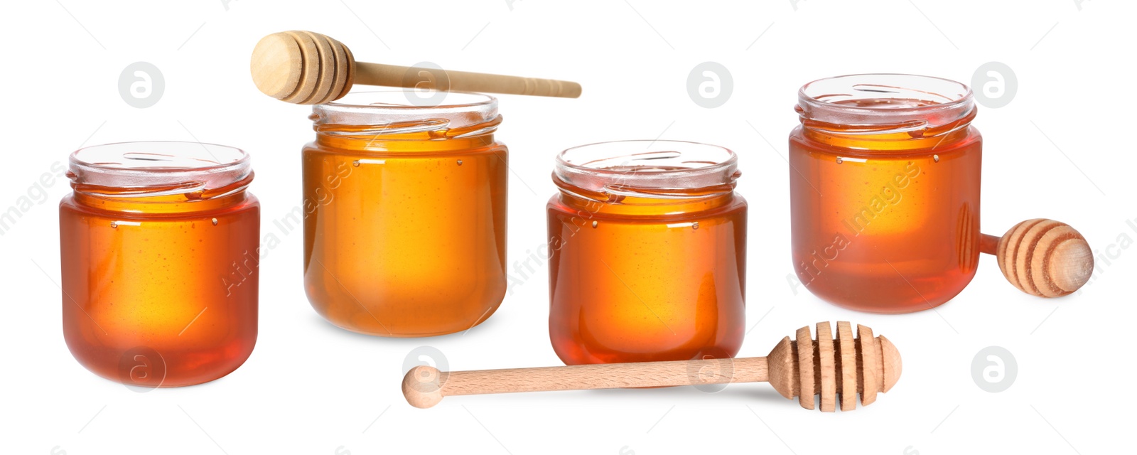 Image of Natural honey in glass jars and dippers isolated on white, set