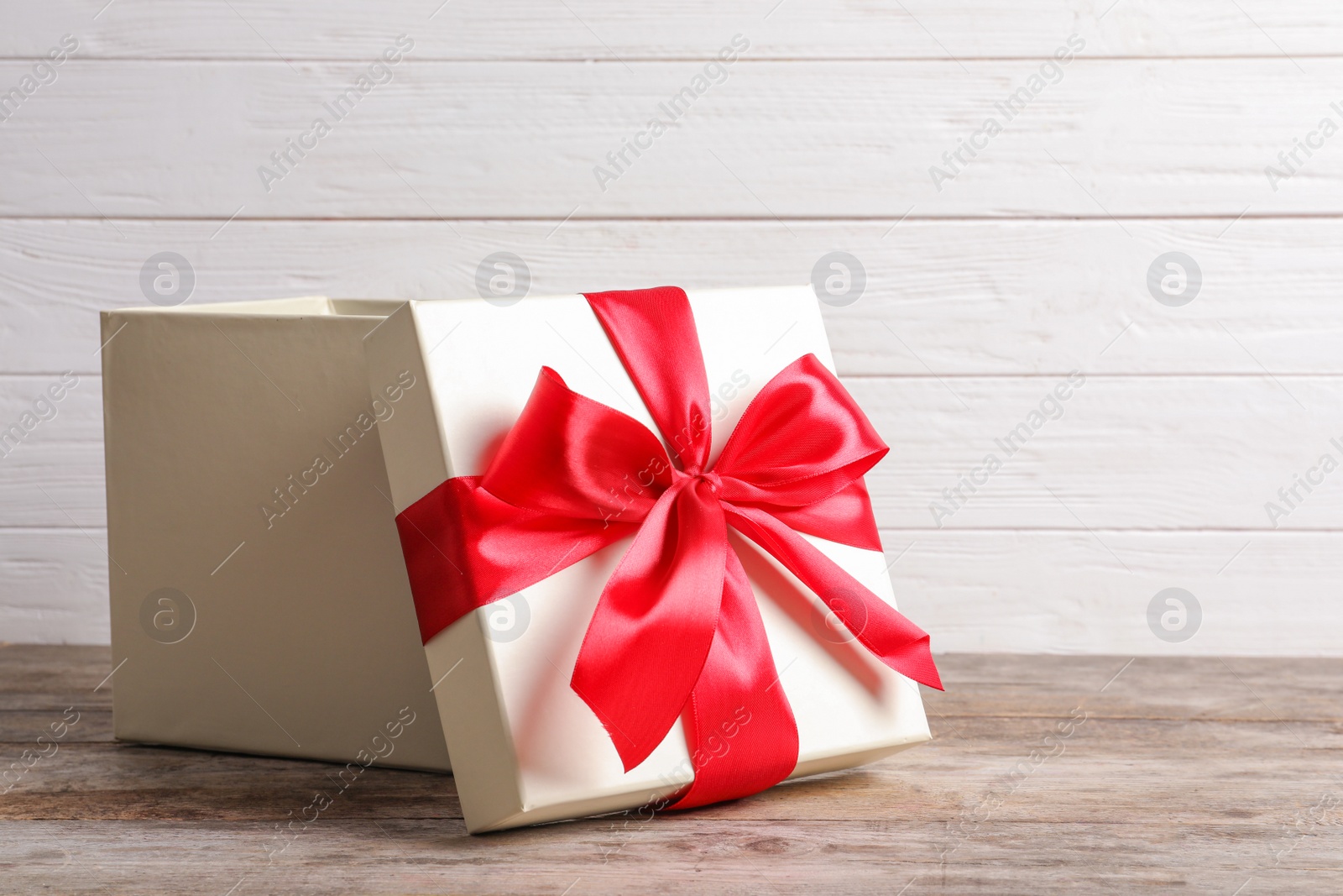 Photo of Open gift box on wooden table