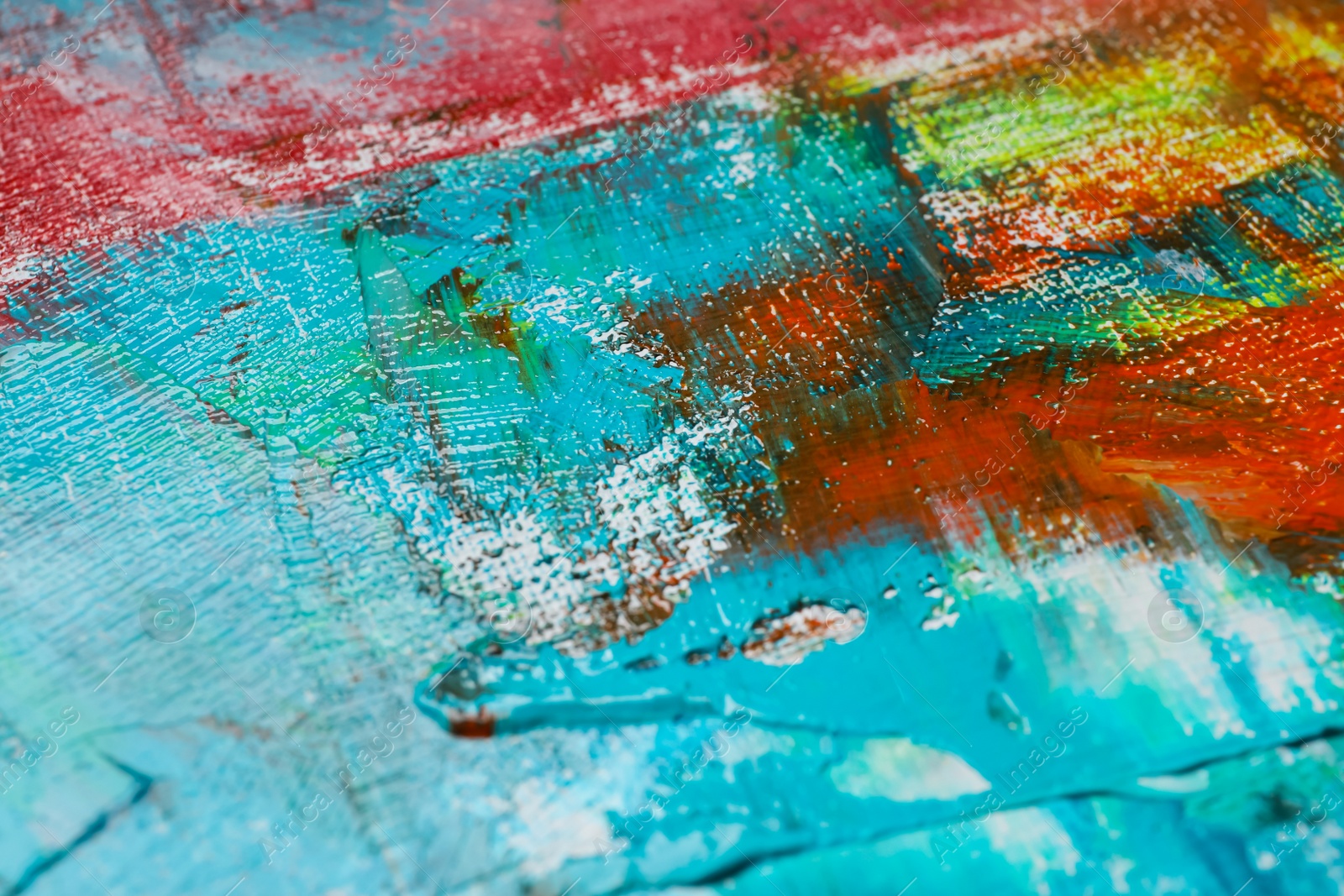 Photo of Strokes of colorful acrylic paints on canvas, closeup