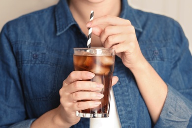 Photo of Woman with glass of tasty refreshing cola, closeup view