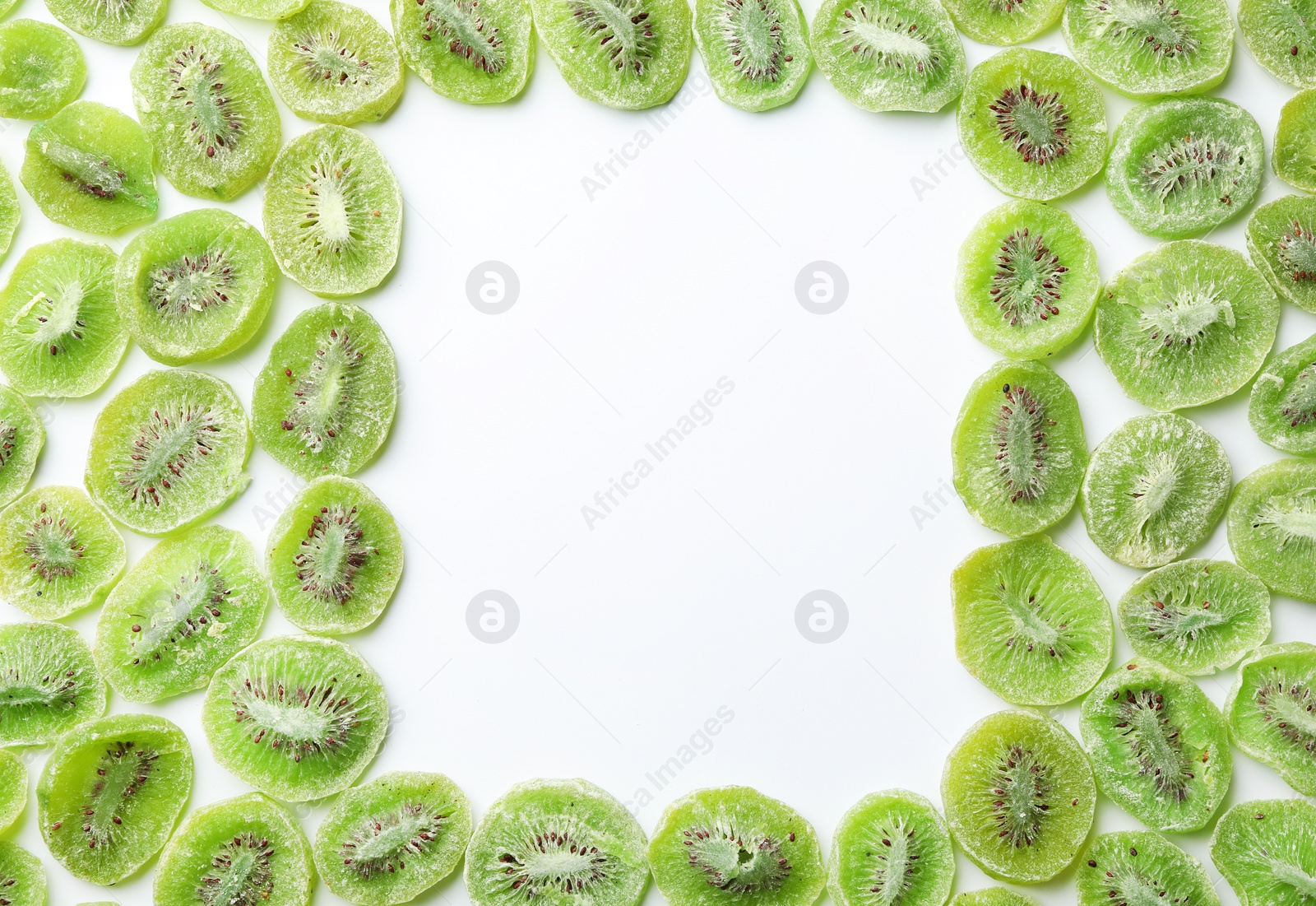 Photo of Frame made of kiwi on white background, flat lay. Dried fruit as healthy food