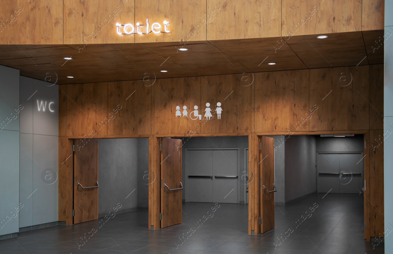 Image of Public toilet signs on wooden wall over entrance