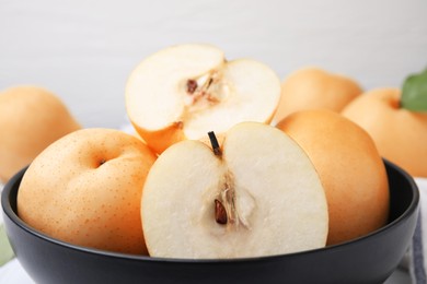Photo of Bowl with delicious apple pears, closeup view
