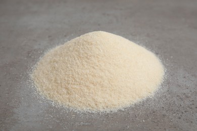 Pile of gelatin powder on grey table