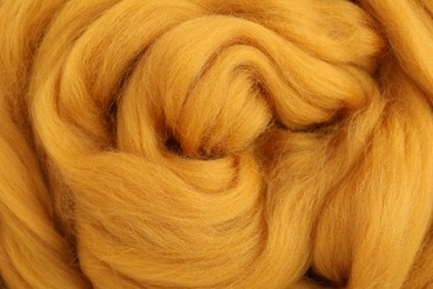 Photo of Orange felting wool as background, closeup view