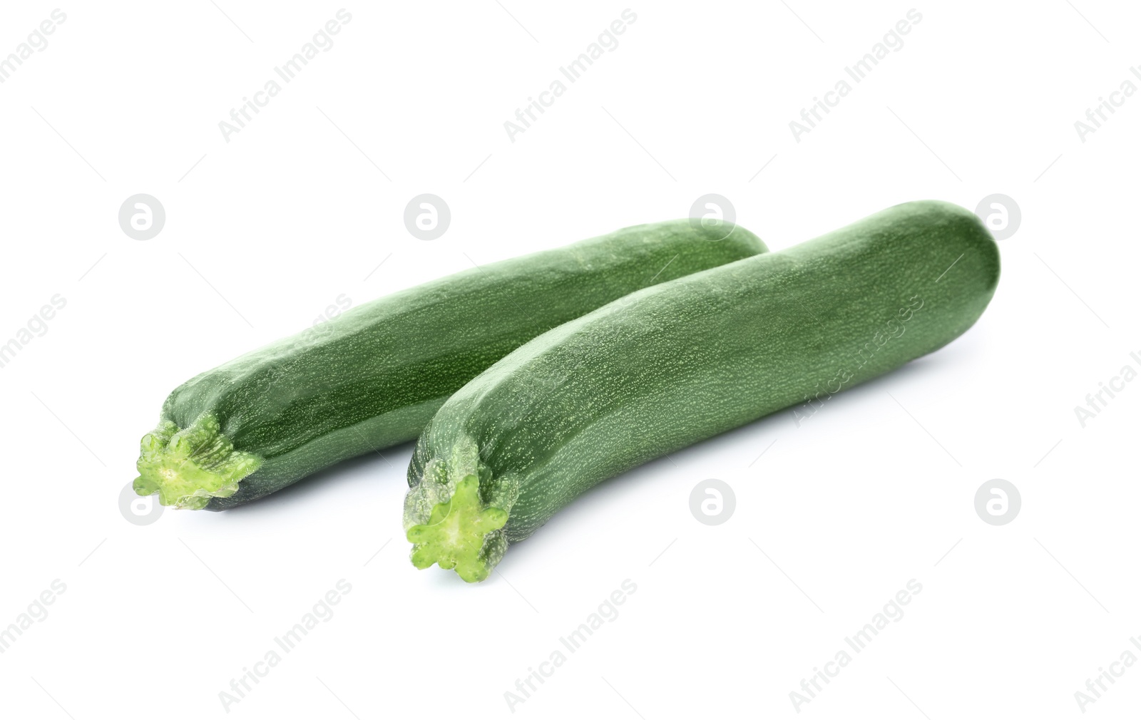 Photo of Raw green ripe zucchinis isolated on white