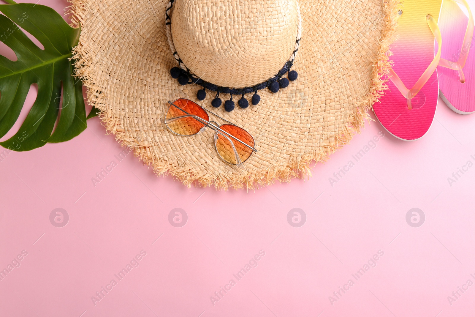 Photo of Flat lay composition with stylish hat and beach objects on color background
