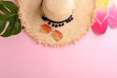 Flat lay composition with stylish hat and beach objects on color background