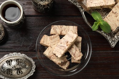 Photo of Tasty chocolate halva served on wooden table, flat lay