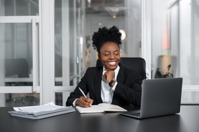 Happy woman working at table in office. Lawyer, businesswoman, accountant or manager