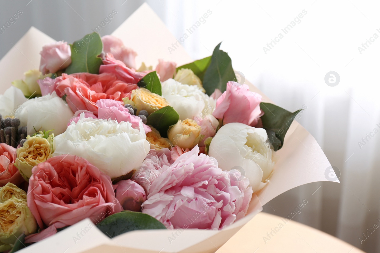 Photo of Beautiful flower bouquet in front of window, closeup