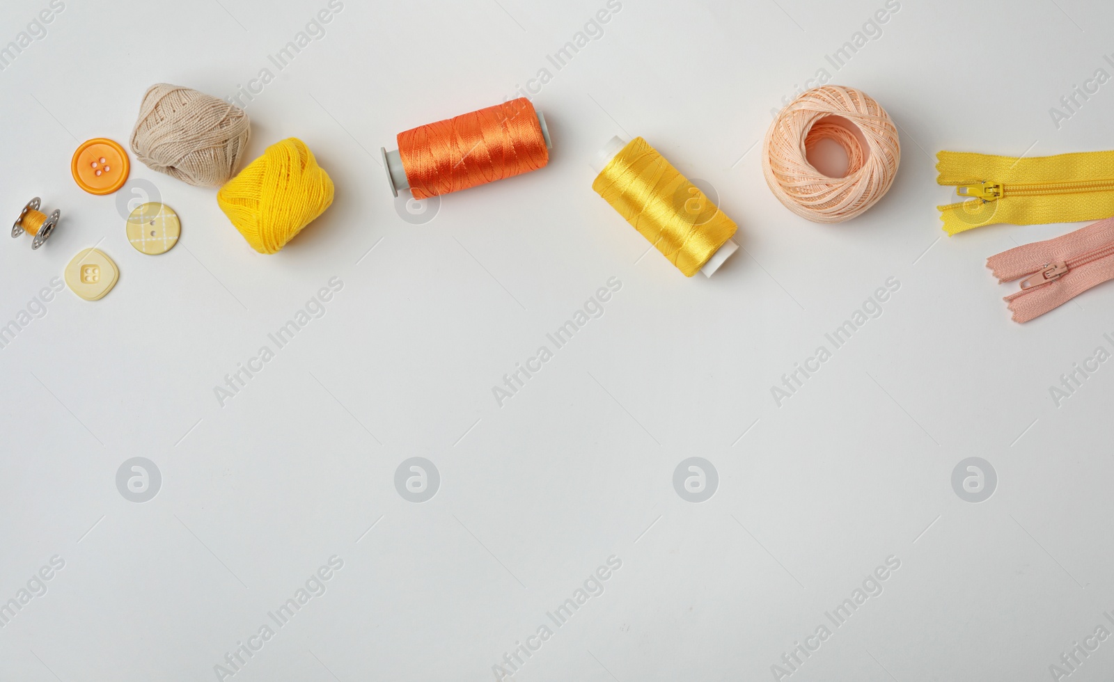 Photo of Composition with color sewing threads on white background, top view