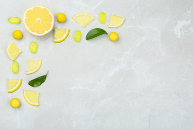 Photo of Flat lay composition with lemon drops on grey marble table. Space for text