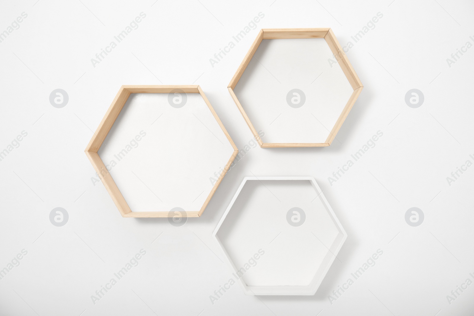 Photo of Empty honeycomb shaped shelves on white wall