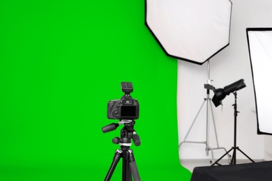 Image of Chroma key compositing. Camera, green backdrop and equipment in studio