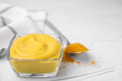 Photo of Tasty curry sauce and powder on white table, closeup. Space for text