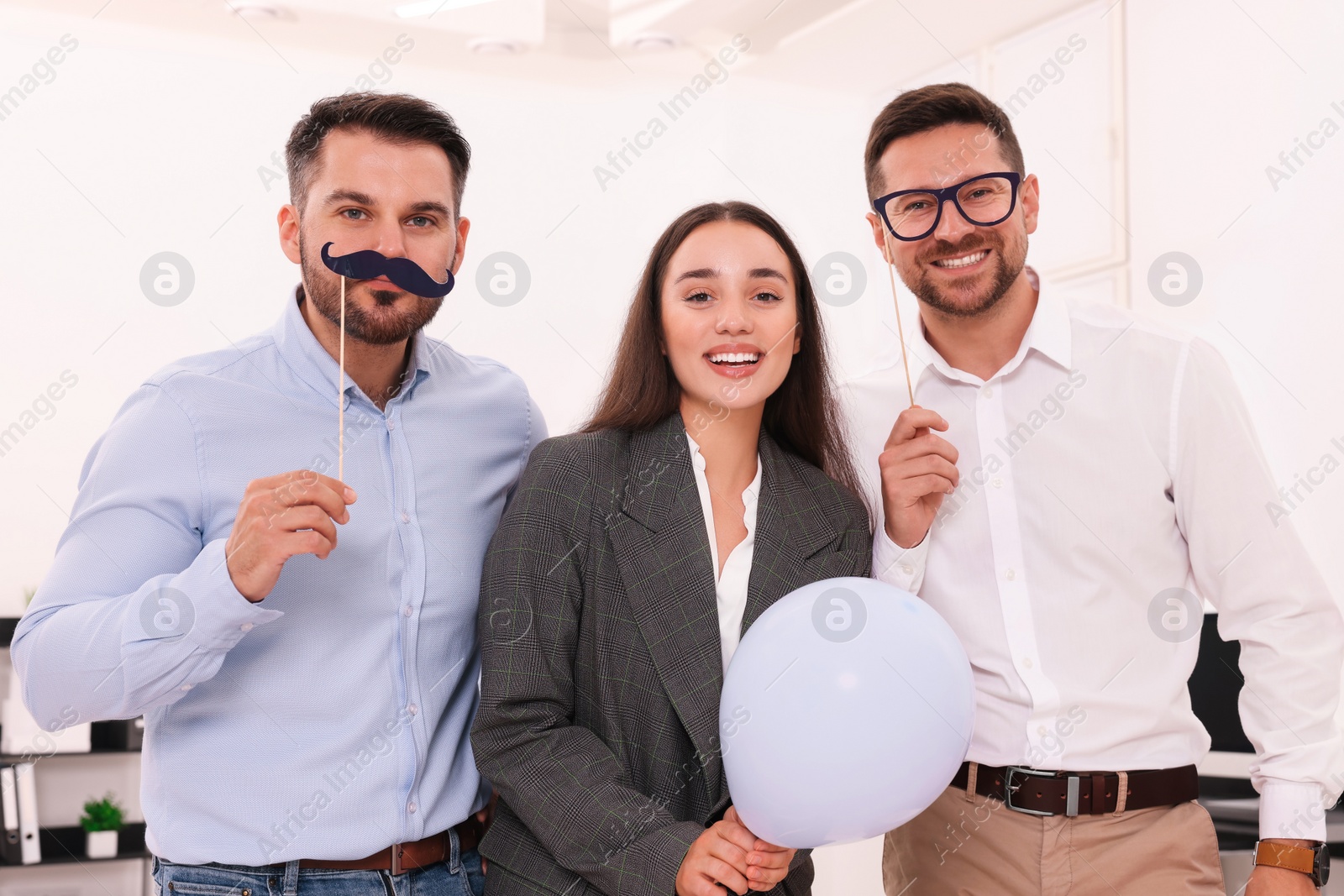 Photo of Coworkers having fun during office party indoors