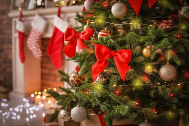 Photo of Beautiful Christmas tree with decor and gift boxes indoors