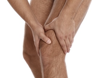 Photo of Man suffering from knee pain on white background, closeup